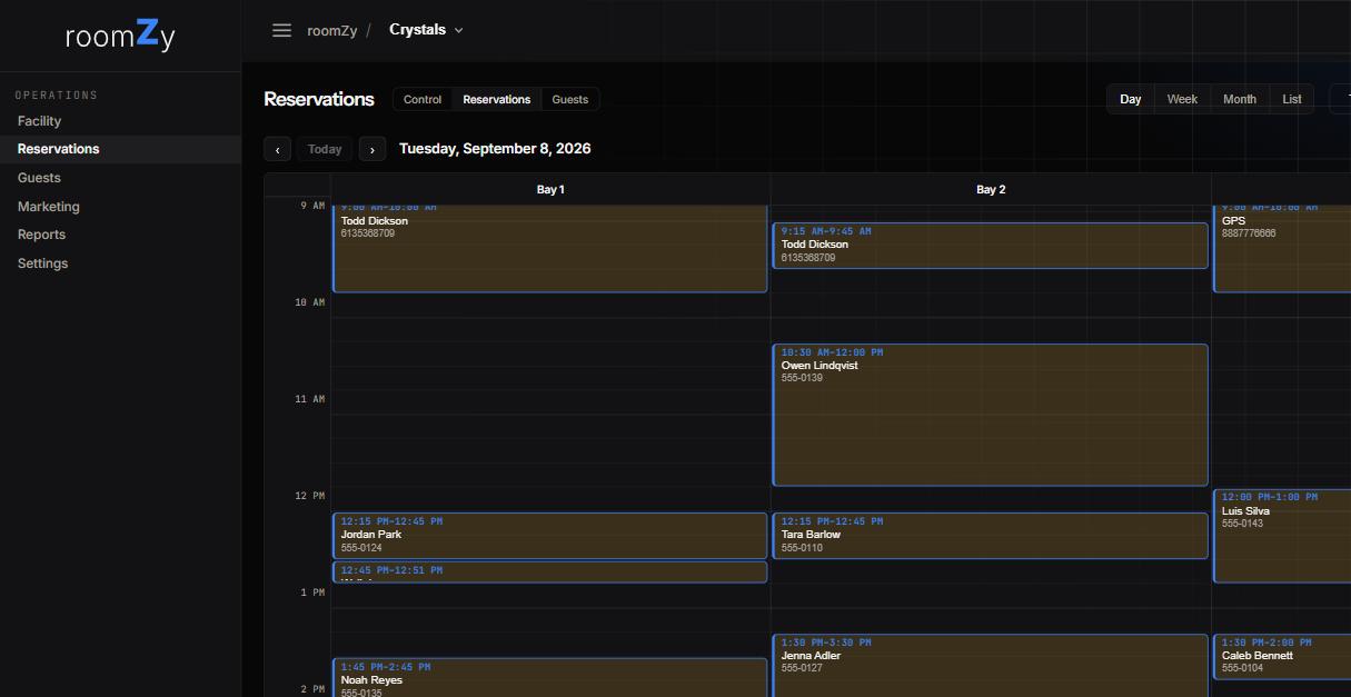 The reservations calendar, Day view: bays as columns, bookings as blocks with name and phone, and Day/Week/Month/List switchers.